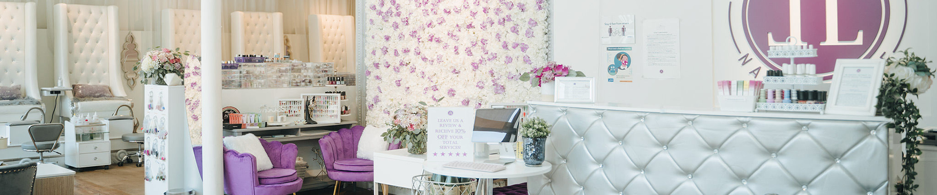Little Luxuries Nail Lounge reception area with desk and chairs